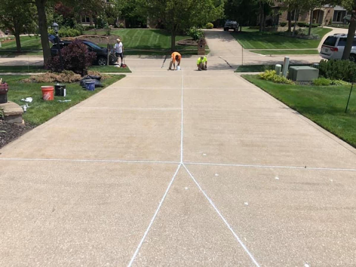 Infinity Caulking crew working on driveway joint caulking