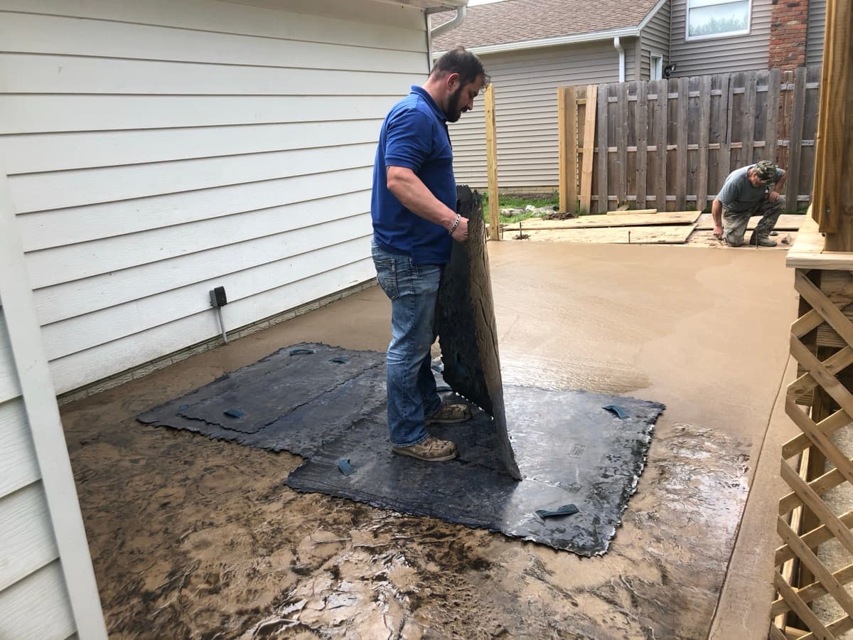 Stamping fresh concrete patio